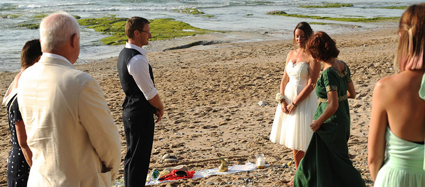 Maori wedding ceremony in a beach, standing in circle